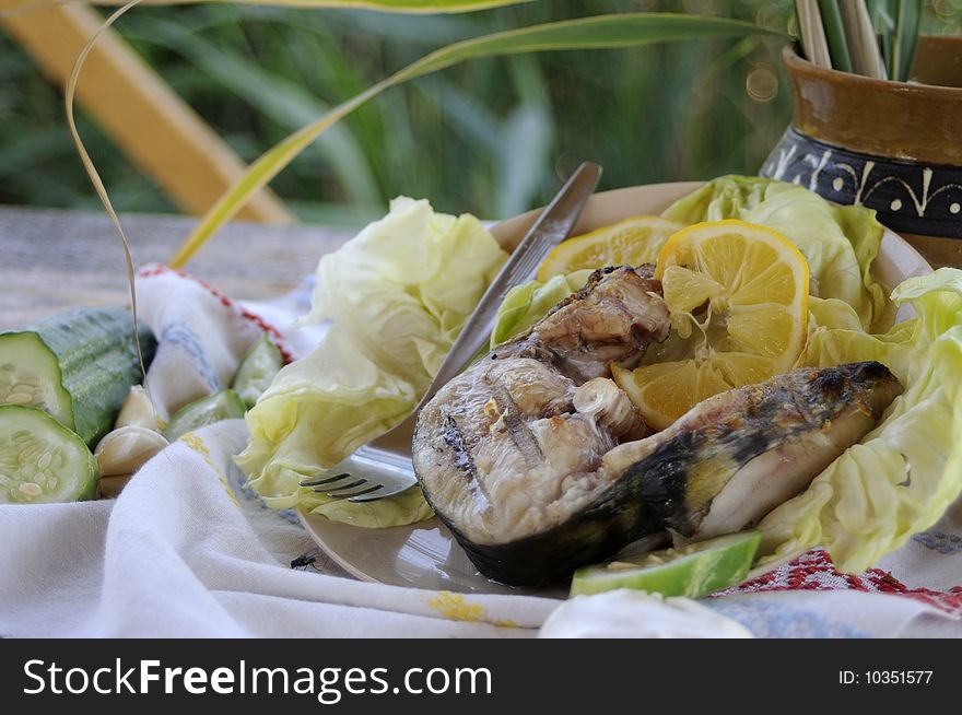Close up with healthy fish, sheatfish, with lemon. Close up with healthy fish, sheatfish, with lemon