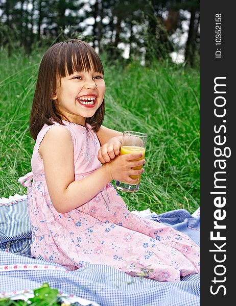 Little girl with orange juice laughing. Little girl with orange juice laughing