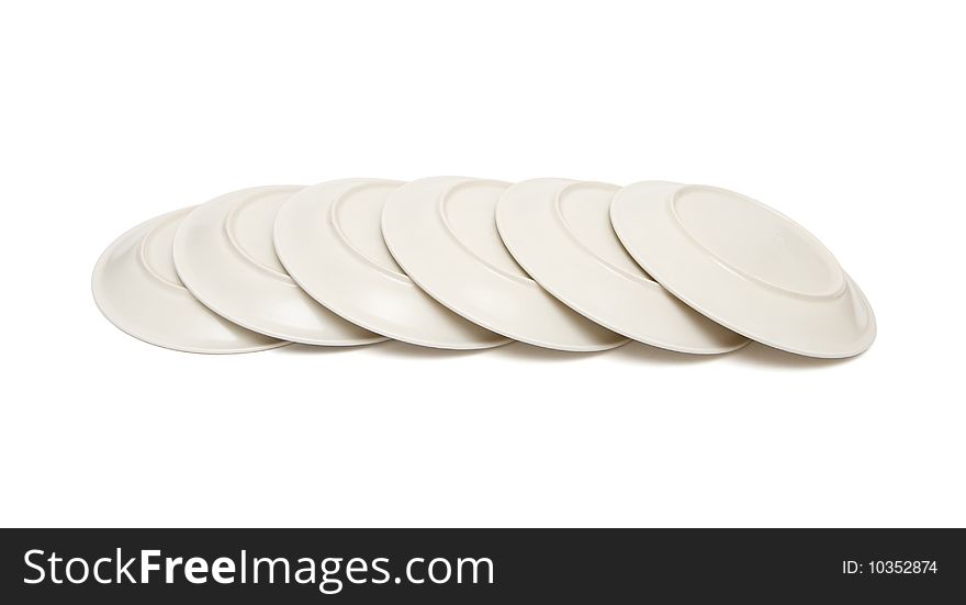 Stack of plain beige plates tiled upside down isolated. Stack of plain beige plates tiled upside down isolated