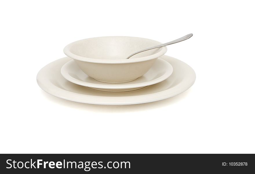 Plain beige soup, dinner plates and saucer with spoon isolated. Plain beige soup, dinner plates and saucer with spoon isolated