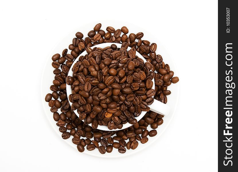 Mug filled with coffee beans, top view