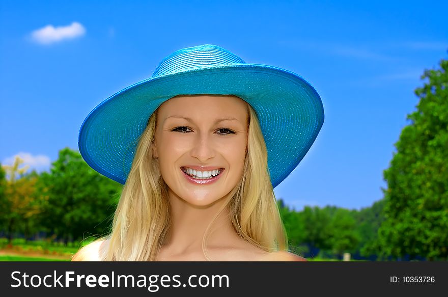 Closeup portrait of beautiful blond young woman with hat over blue sky background. Closeup portrait of beautiful blond young woman with hat over blue sky background.