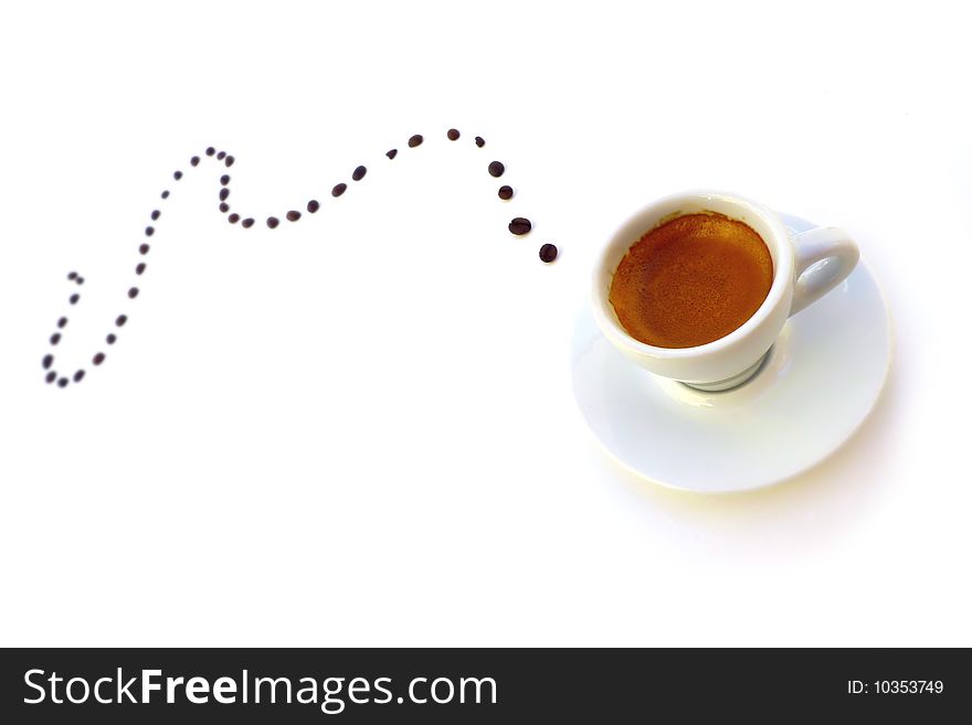 Expresso cup with trail of coffee beans. Expresso cup with trail of coffee beans.