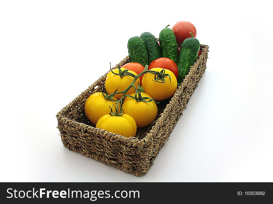 Yellow tomatos, red tomato, cuke, basket