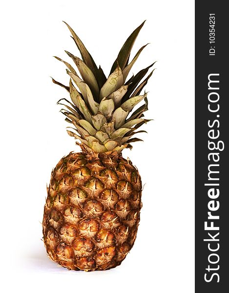 Fresh pineapple standing isolated on a white background