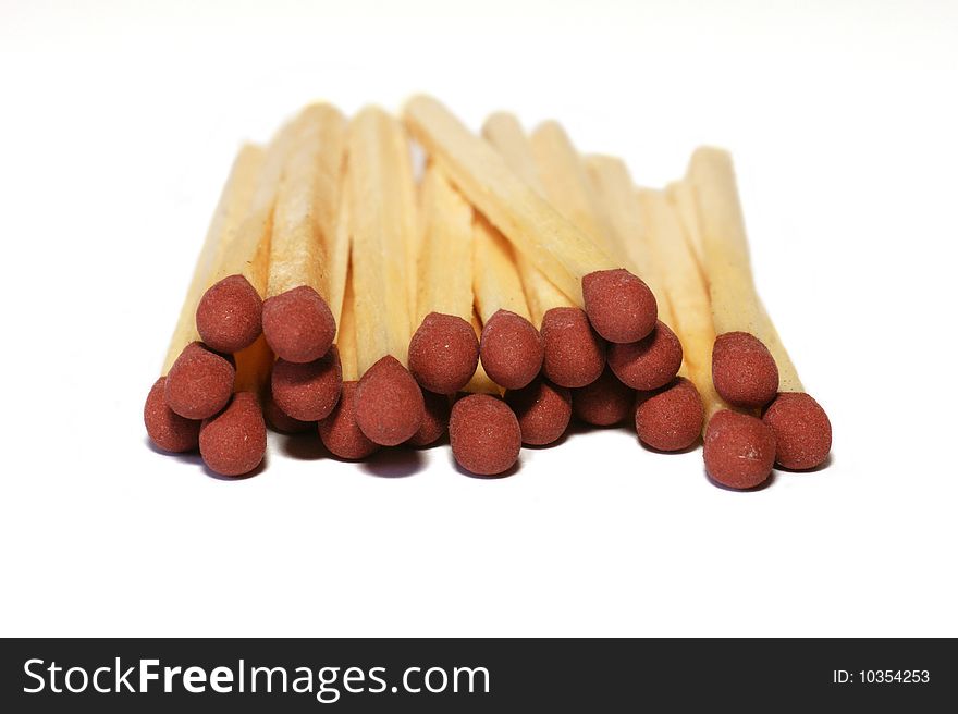 Amount of redheaded matches lying isolated on a white background