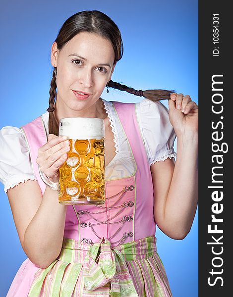 A traditionally dressed Bavrian Girl with pigtails and beer. A traditionally dressed Bavrian Girl with pigtails and beer