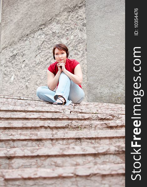 Modern young woman thinking on ancient staircase. Modern young woman thinking on ancient staircase