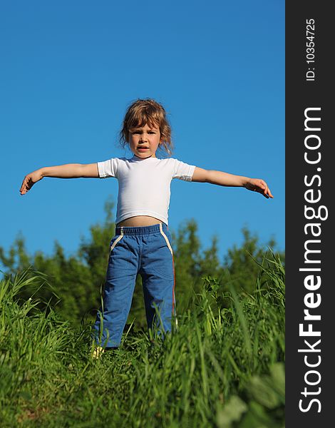 Girl makes gymnastic in grass