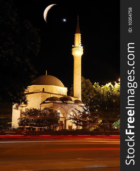 Mosque, crescent and star, traffic and lights at night