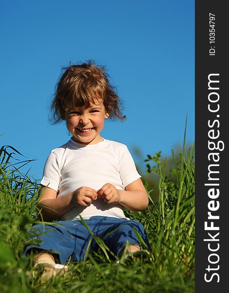 Portrait Of Smiling Girl  Sitting In Grass