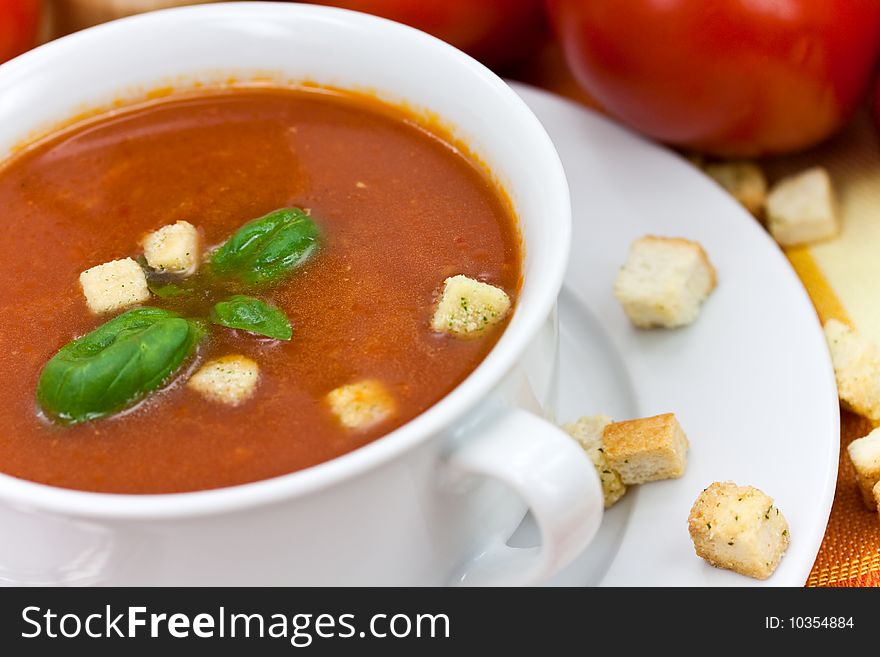 Tomato soup in white bowl.