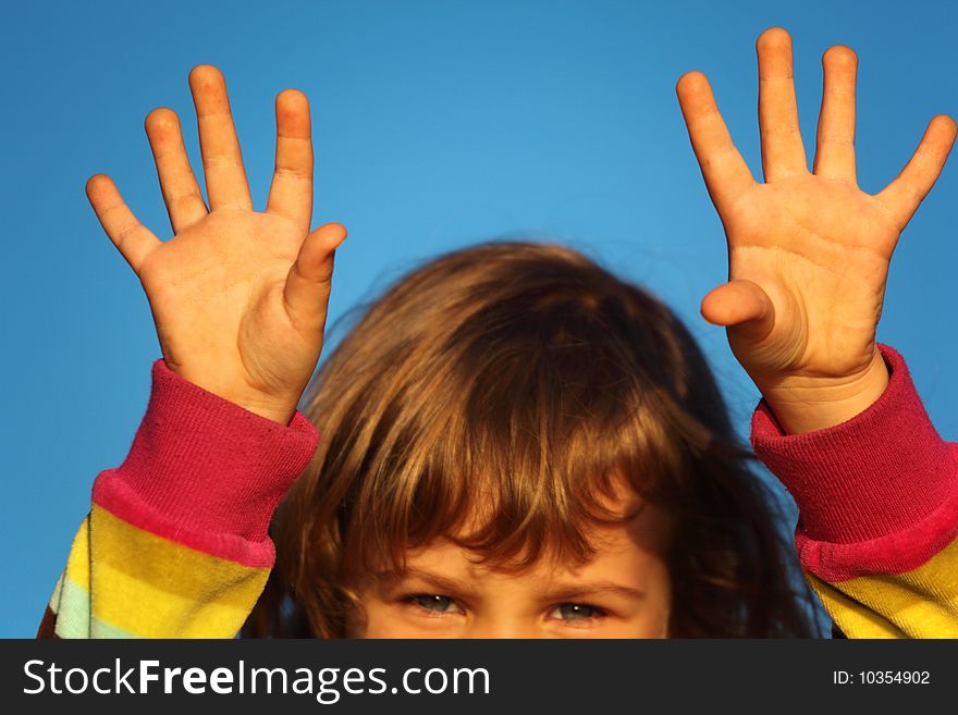 Little girl with lifted hands closeup