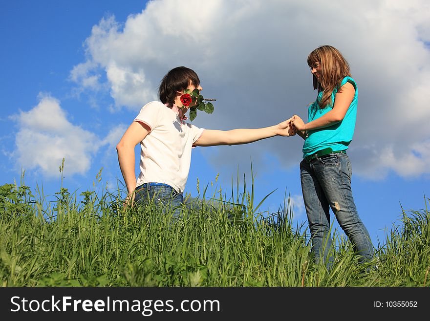 Guy with rose in mouth and girl