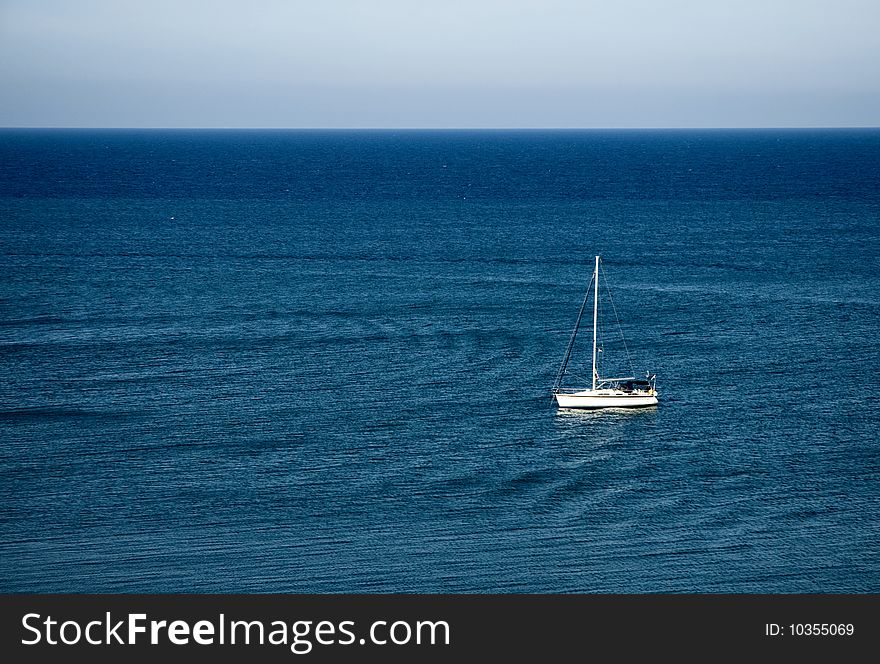 Rowing sailing boat in blue sea - Sardinia - Italy