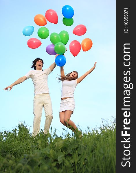 Girl and guy start multi-coloured balloons