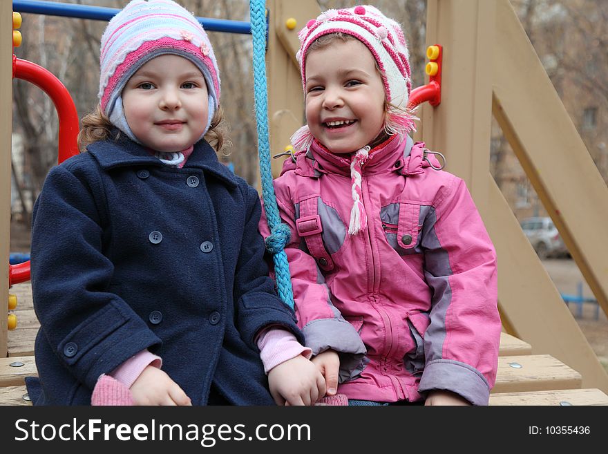 Two smiling little girls on playground. Two smiling little girls on playground