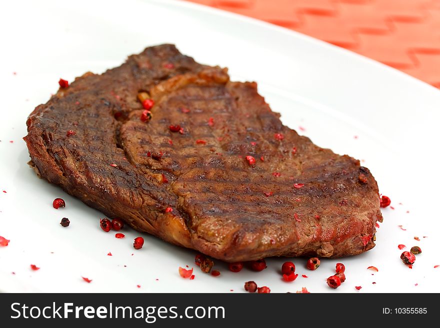 Rib Eye Steak on the white Plate.