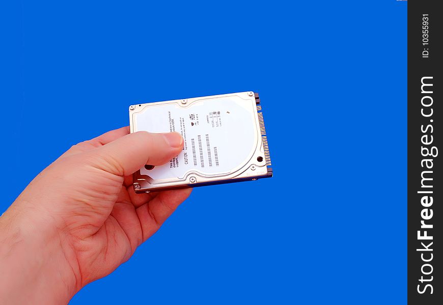 Hand holding laptop hard drive-Blue Background