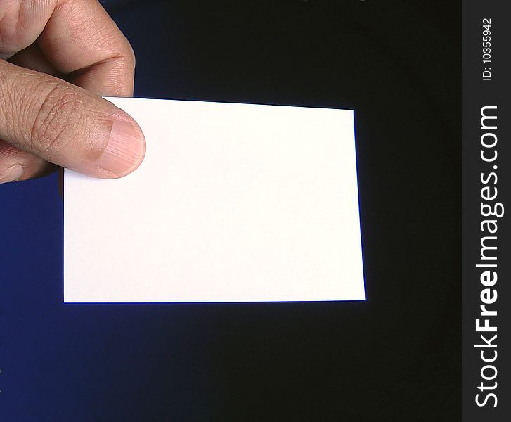 Close up view of fingers holding a  business card free to write what you want on it. Close up view of fingers holding a  business card free to write what you want on it