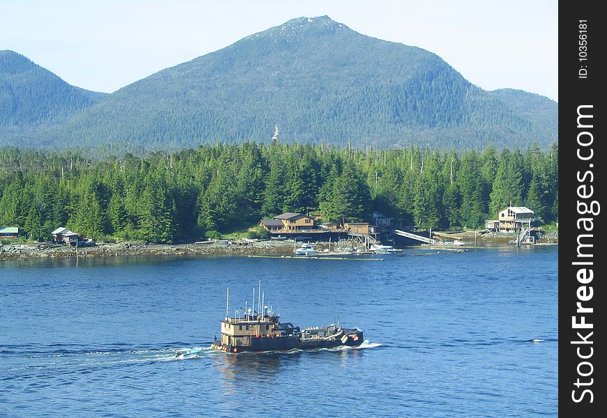 Tug boat in Ketchikan, Alaska with mountains behind
