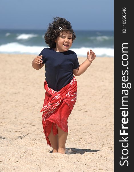 Cute little girl dancing on the beach