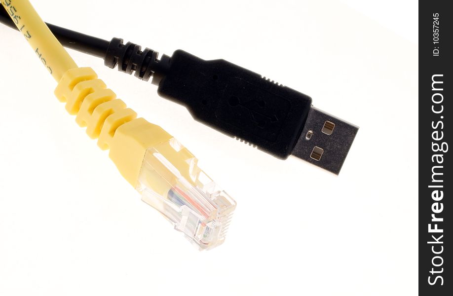 A yellow lan and a black usb connector over a white background. A yellow lan and a black usb connector over a white background.