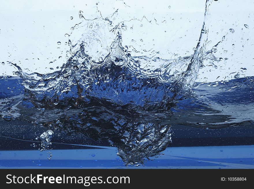 Close up of splash in water in blue tones