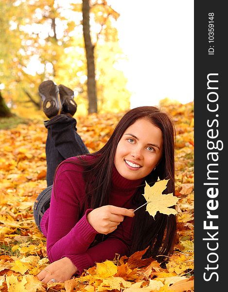 Young beautiful woman in the autumn park. Young beautiful woman in the autumn park