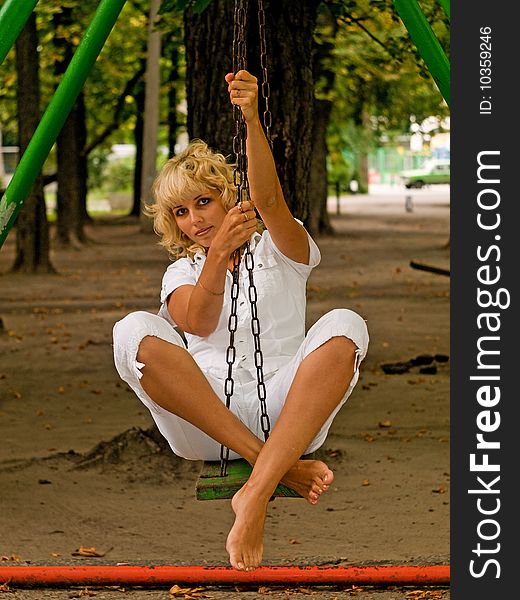 Girl Sitting On The Seesaw