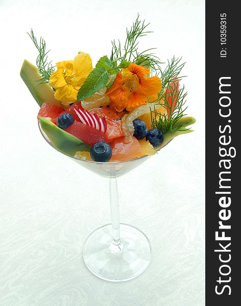 Fruit salad in a glass on a white cloth