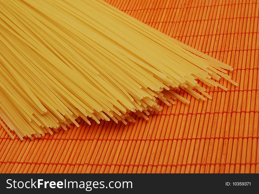 Pasta over orange bamboo mat