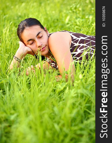 Young woman resting in green meadow