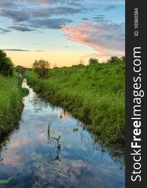 Sunset above the stream vertical