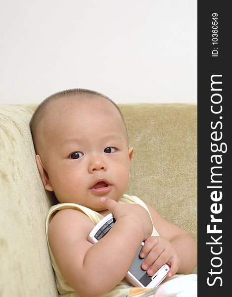 It is a cute chinese baby, he is taking a cell phone, he is 7 months. It is a cute chinese baby, he is taking a cell phone, he is 7 months.