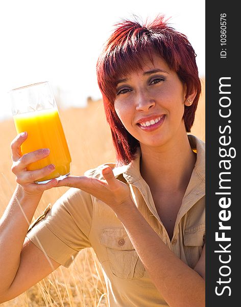 Woman shows a glass of juice with vitamin c. Woman shows a glass of juice with vitamin c