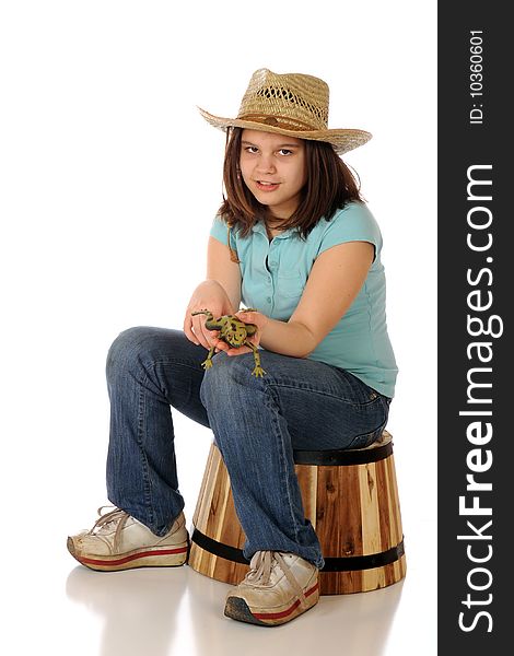 A reteen farm girl showing the viewer a green, spotted frog. Isolated on white. A reteen farm girl showing the viewer a green, spotted frog. Isolated on white.