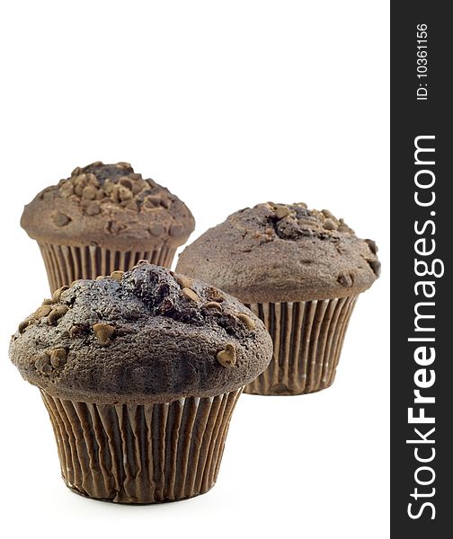 Three Chocolate Muffins with shallow depth of field, isolated on white, vertical with copy space