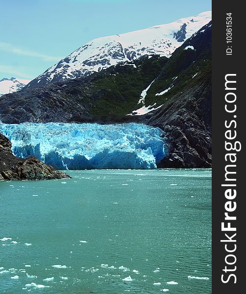 The wall of ice of the Sawyer glacier as it meets the ocean in Tracy Arm fjord. The wall of ice of the Sawyer glacier as it meets the ocean in Tracy Arm fjord