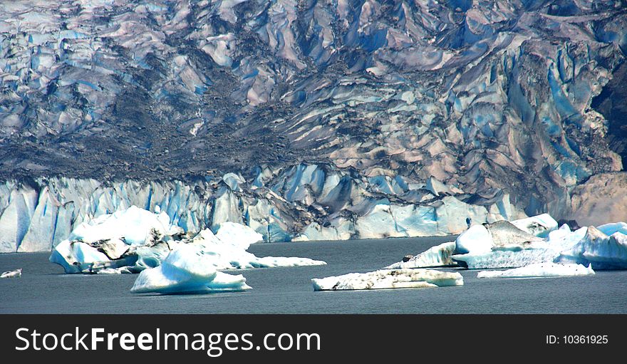 The wall of ice of the Mendenhall glacier, with ice floes in Mendenhall lake. The wall of ice of the Mendenhall glacier, with ice floes in Mendenhall lake