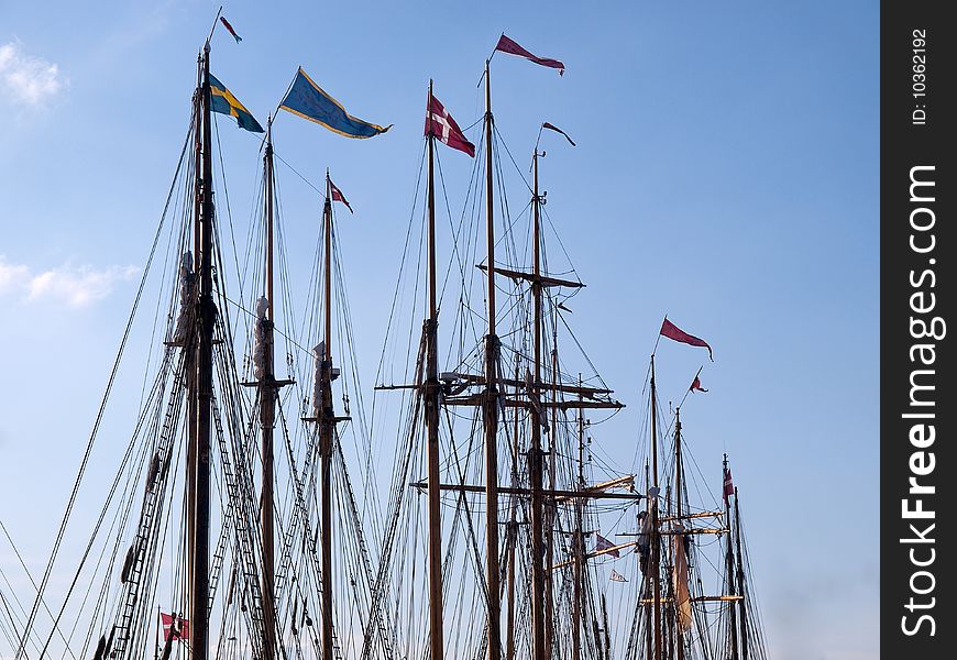 Sailing background line of masts of wooden tall ships
