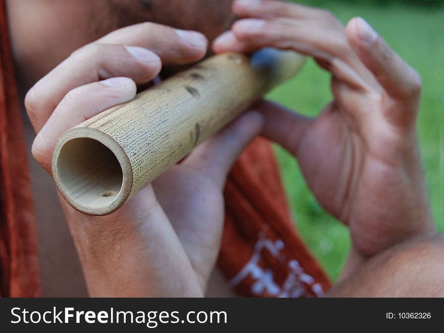 Man plays flute in mountains