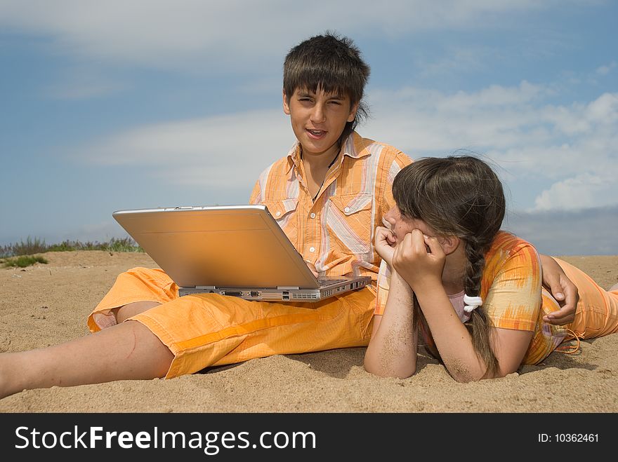 Two teens (brother and sister) with laptops. Two teens (brother and sister) with laptops