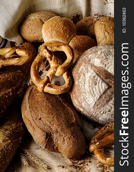 Isolated bread and tasty pretzel with grain and seeds around