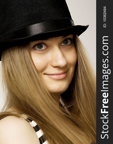 Girl blonde in a funny  black hat. Girl blonde in a funny  black hat