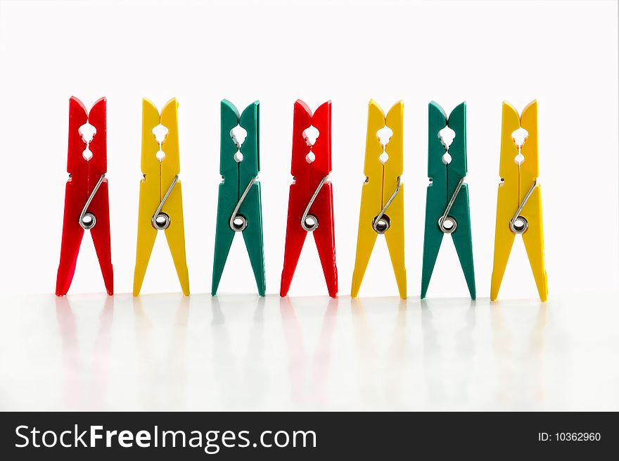 Several clothespins against the white background. Several clothespins against the white background