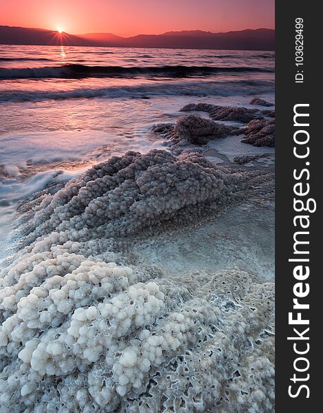 Dead sea sunrise over salt crystals shore - nature of Israel