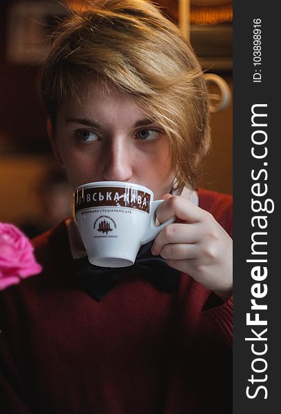 Woman Wearing Red Top Holding Teacup