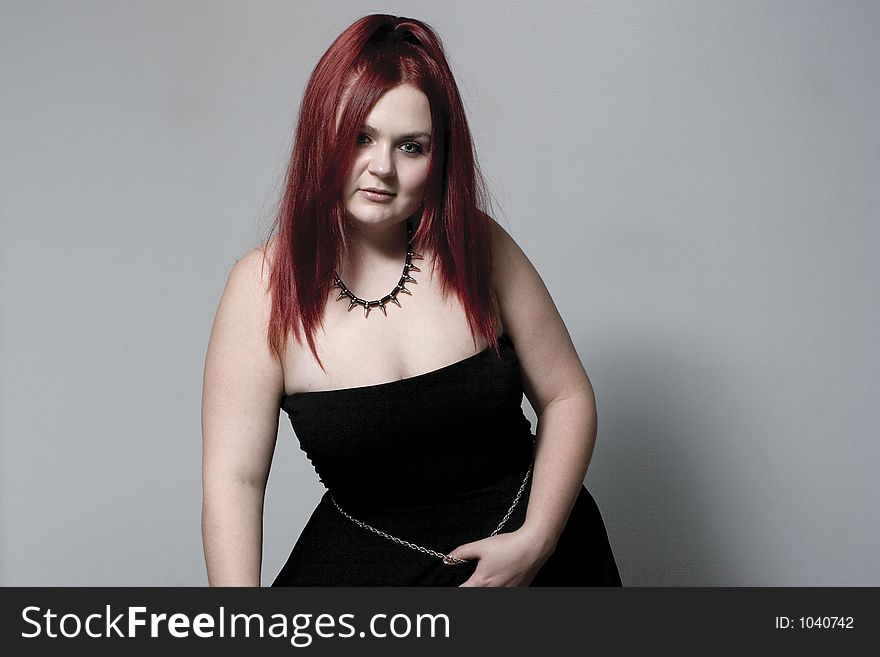 Red hair female model looking down with goth look. Red hair female model looking down with goth look