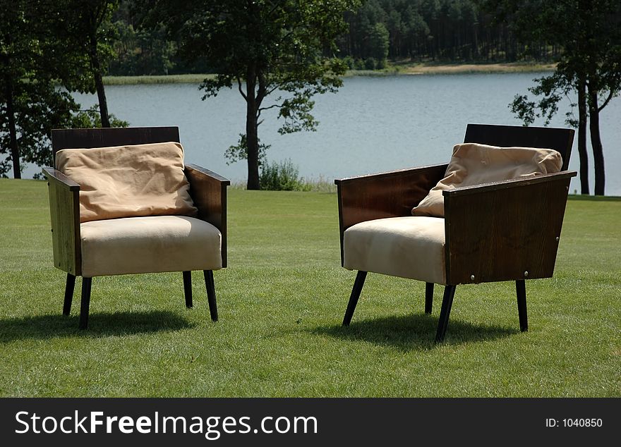 Two arm-chairs on grass